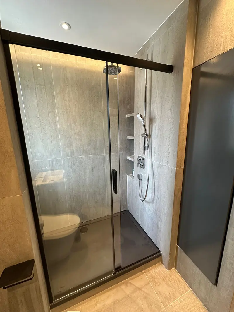 Walk-in shower installation with large format tiles in Weybridge Surrey